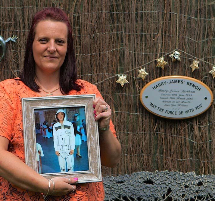 Dawn Kirkham holding a photo of her son, Harry-James