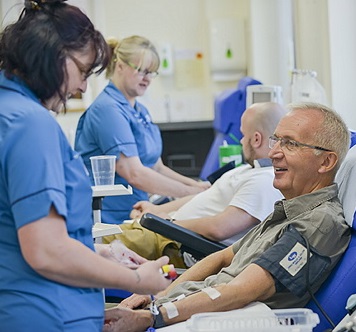A man donates blood at Cambridge Donor Centre