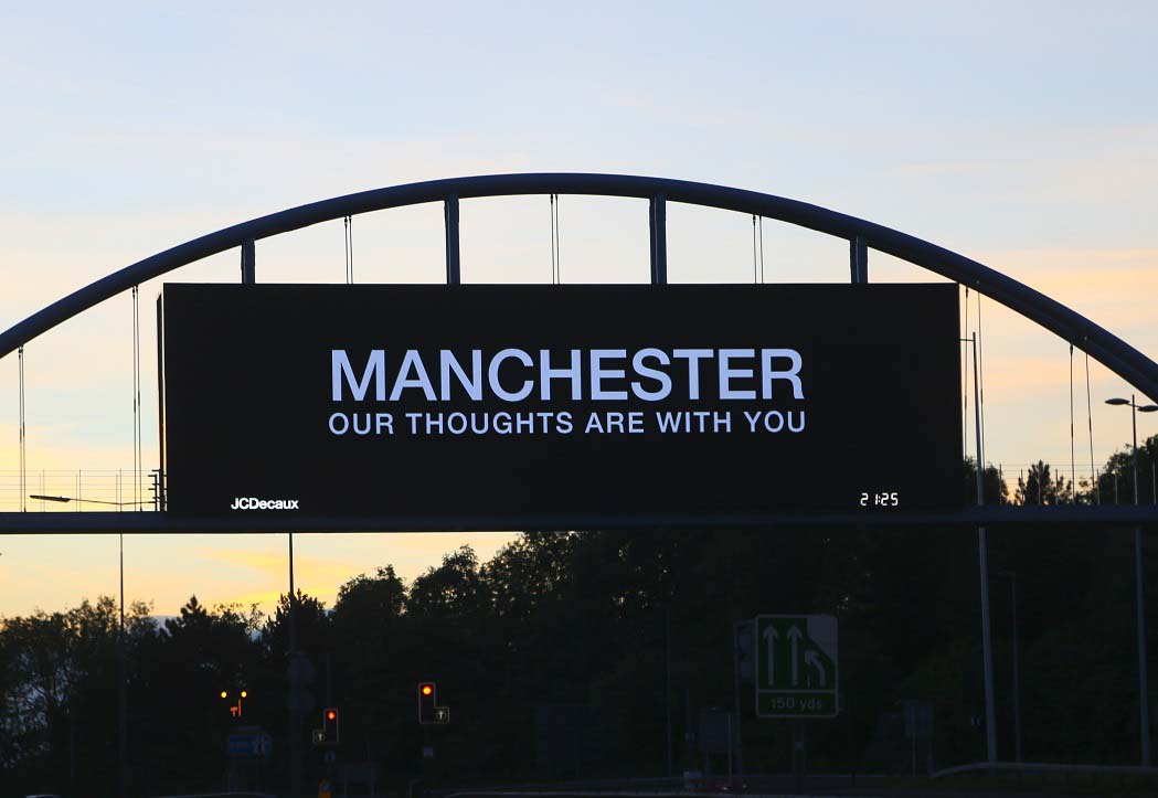 Road sign saying Manchester our thoughts are with you