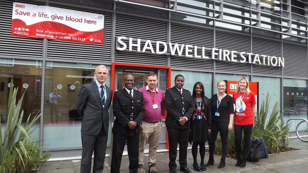Director of Blood Donation Mike Stredder and Senior Sister Ebony Dunkley with staff at Shadwell Fire Station.