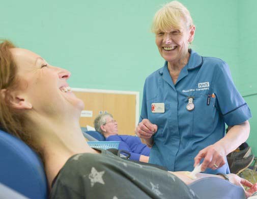 Donor and donor carer at a blood donation session