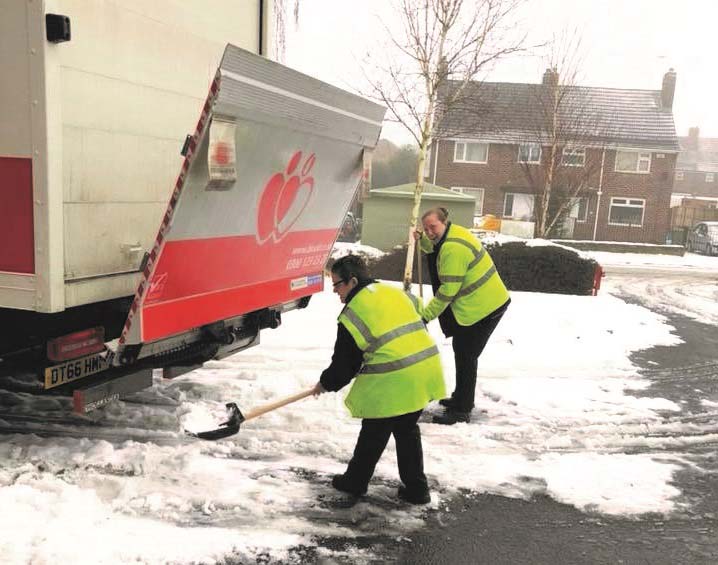 Donor carers clearing the snow