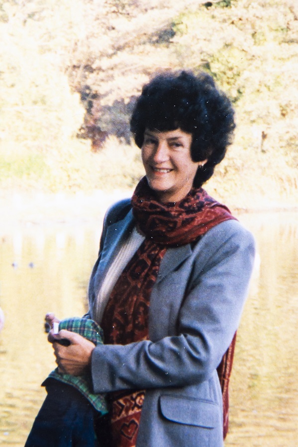 An image of Ann Butler smiling, at the side of a lake