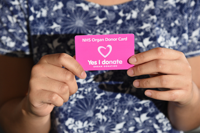 A person holding an organ donor card