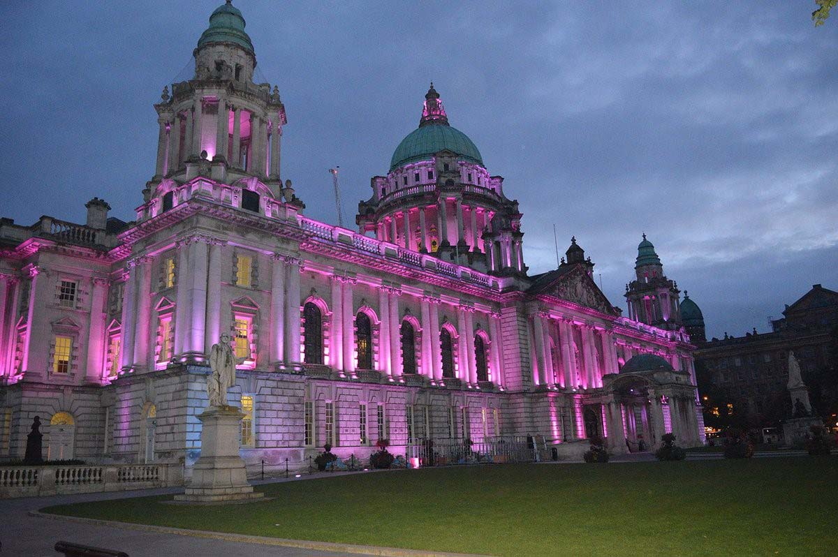 An image of Belfast City Hall bathed in pink light in support of Organ Donation Week 2017