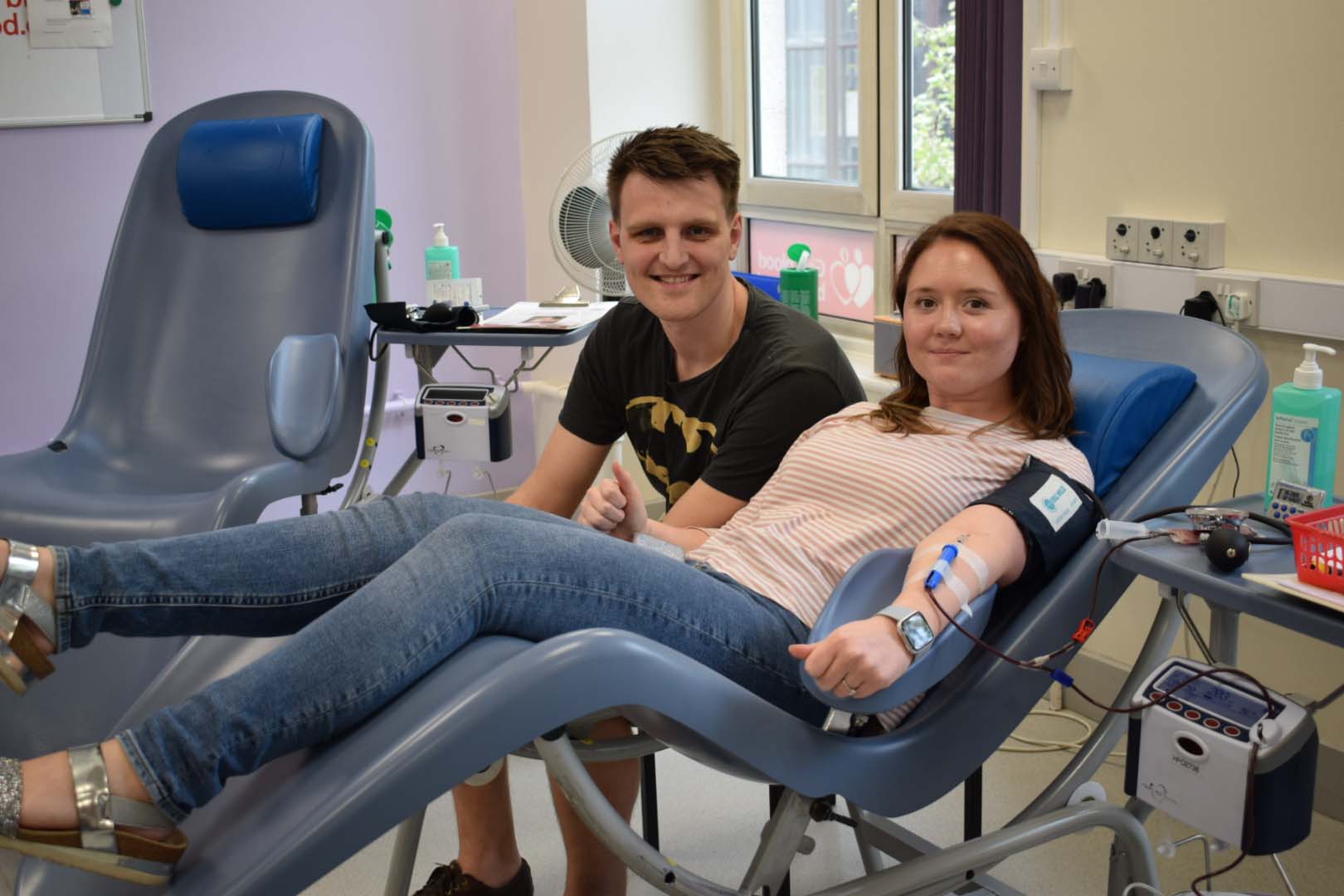 Hannah Cox gives blood while her fiance, Sam Smith, watches