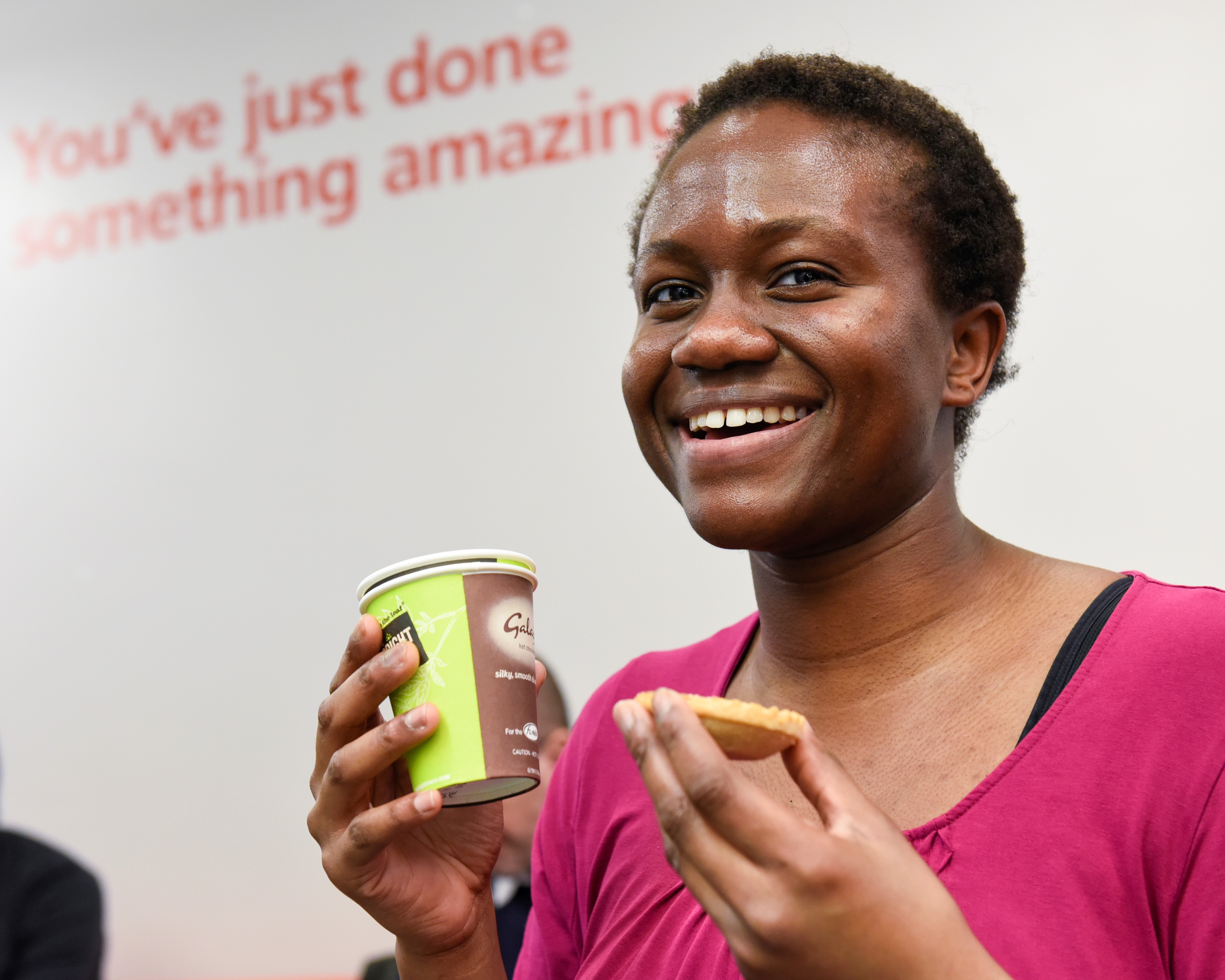 a woman has a drink and biscuit after donating