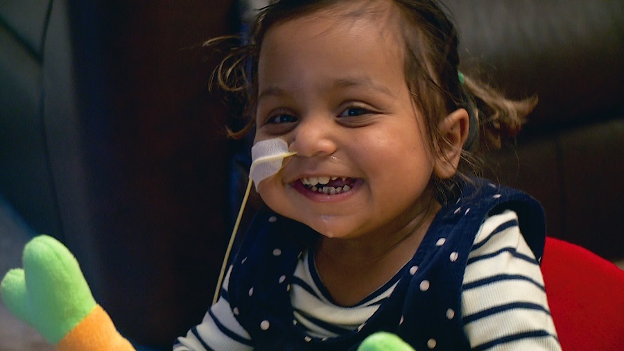 Anaya as a toddler, pictured with a nasogastric tube and smiling