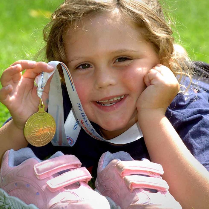 Child holding a medal