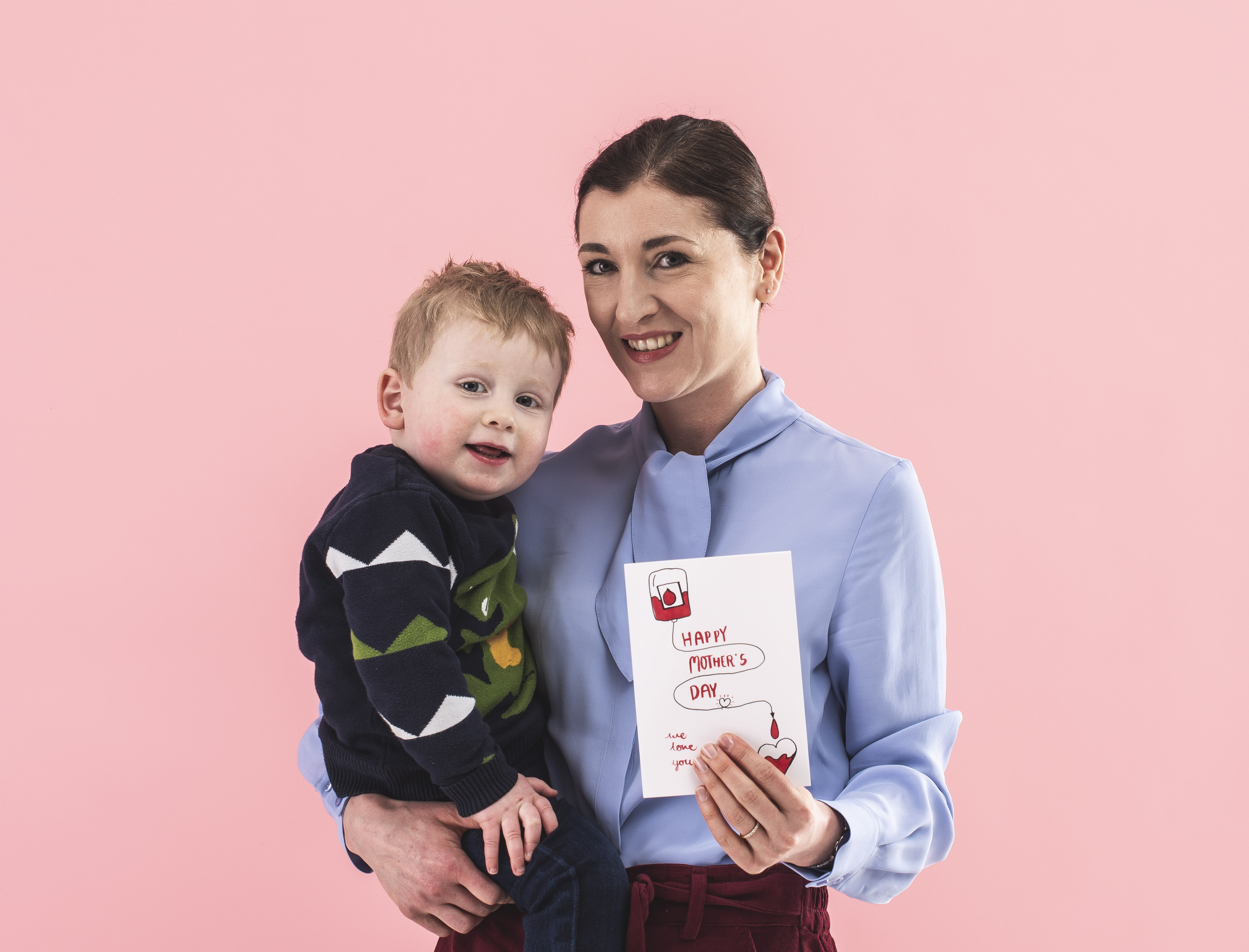 Kirsty holds a card and her toddler son