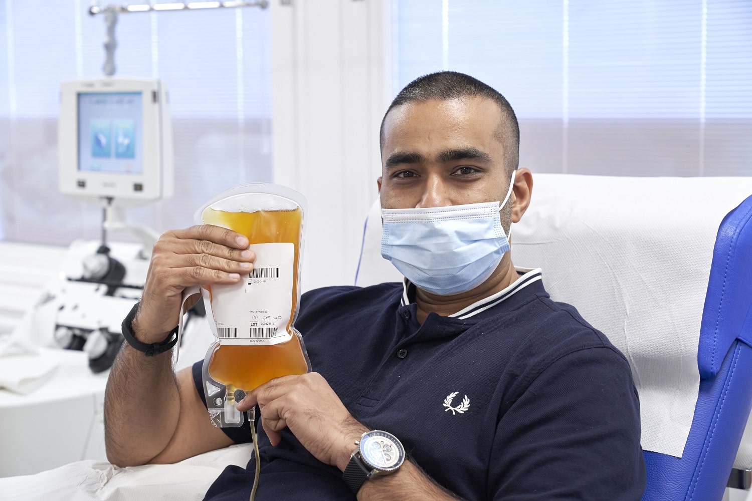 A donor holds a bag of his plasma
