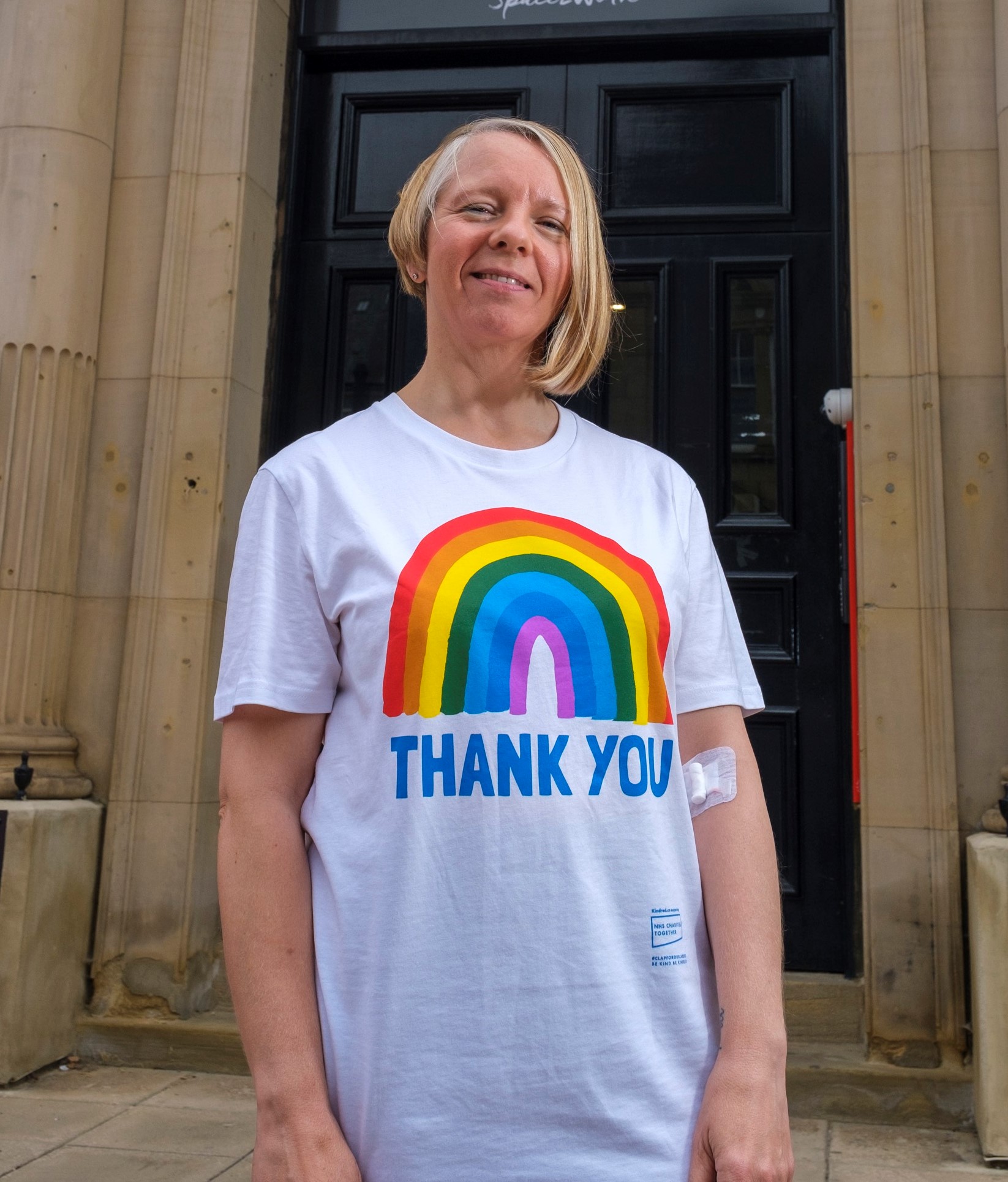 Karen wearing a white T shirt which says Thank you on it with a rainbow
