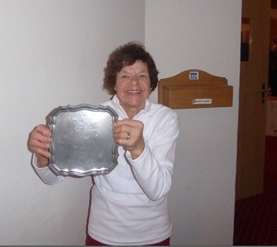 Carol holding a ski trophy
