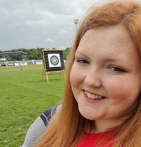 Sophie, smiling at an archery event