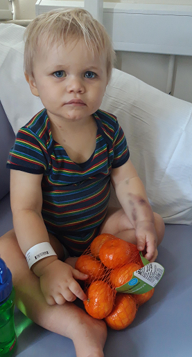 Romeo in hospital, clutching a bag of clementines
