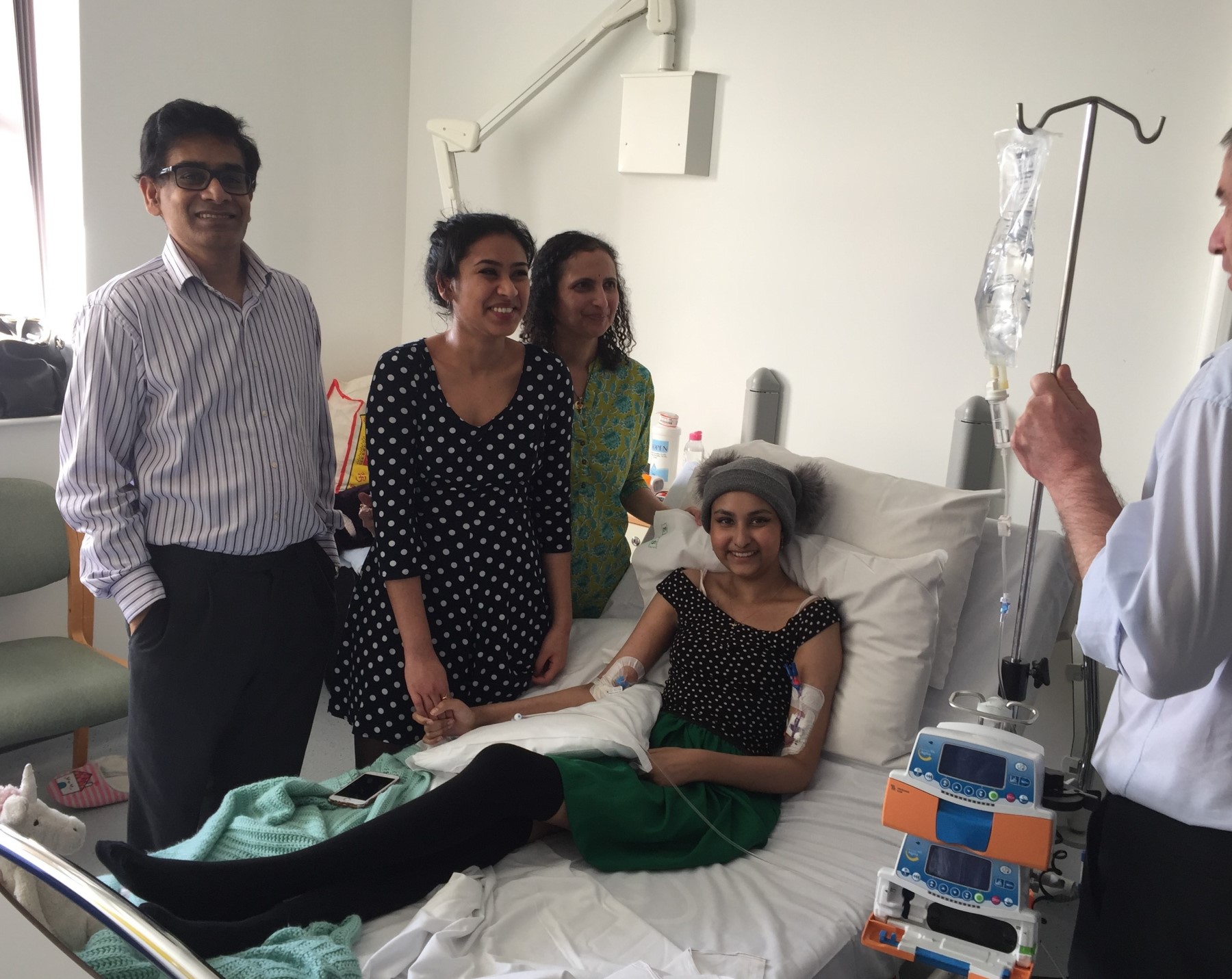 Nitya receiving CAR-T therapy at the hospital with family