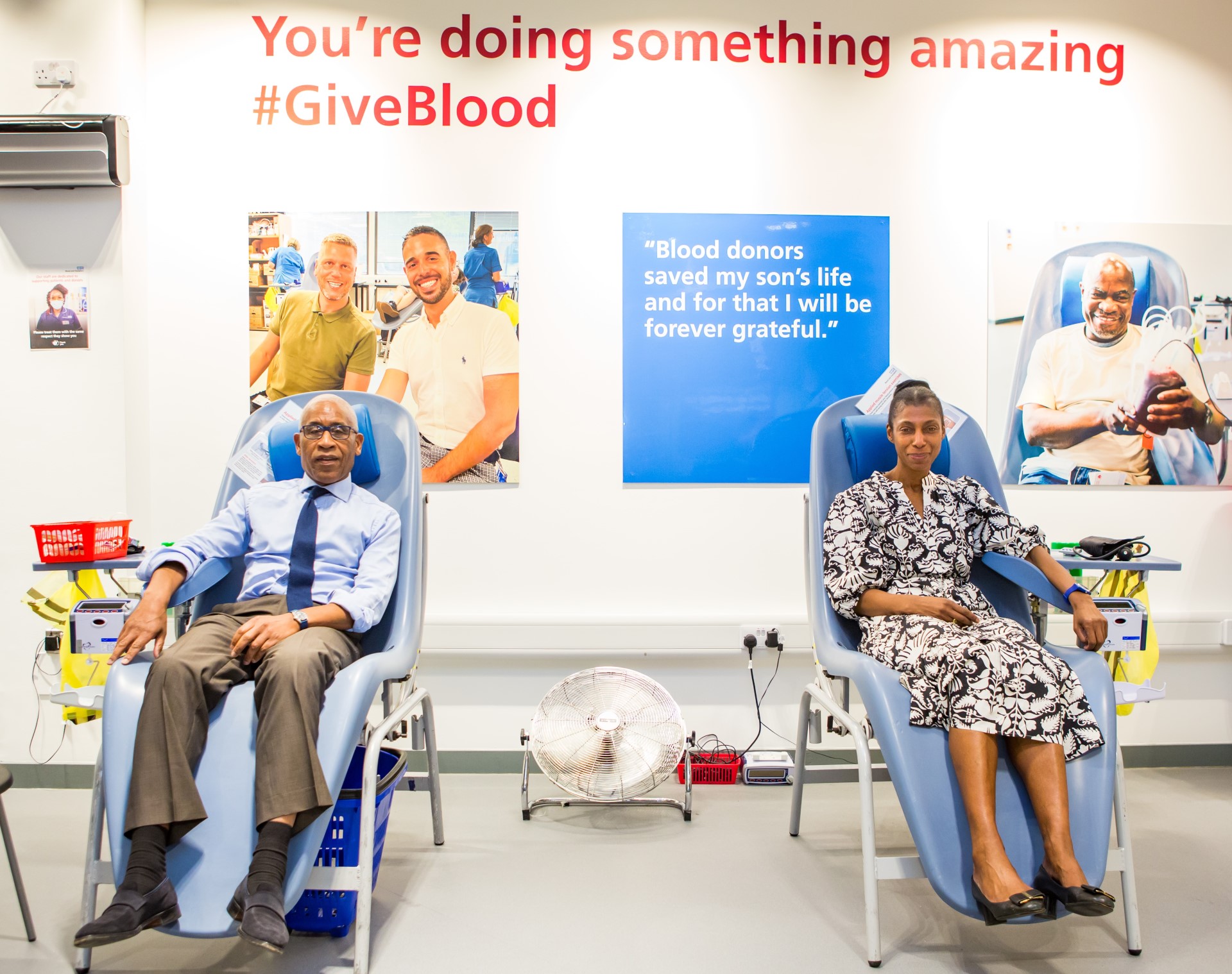 Lord Simon Woolley and Dame Sharon White donating blood
