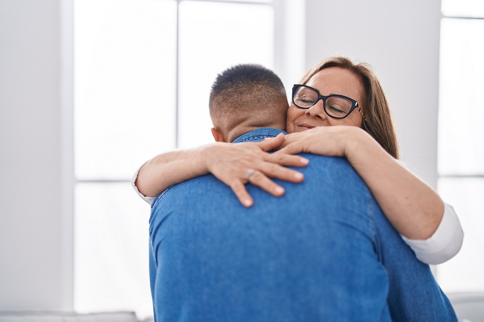 A mother and son hugging