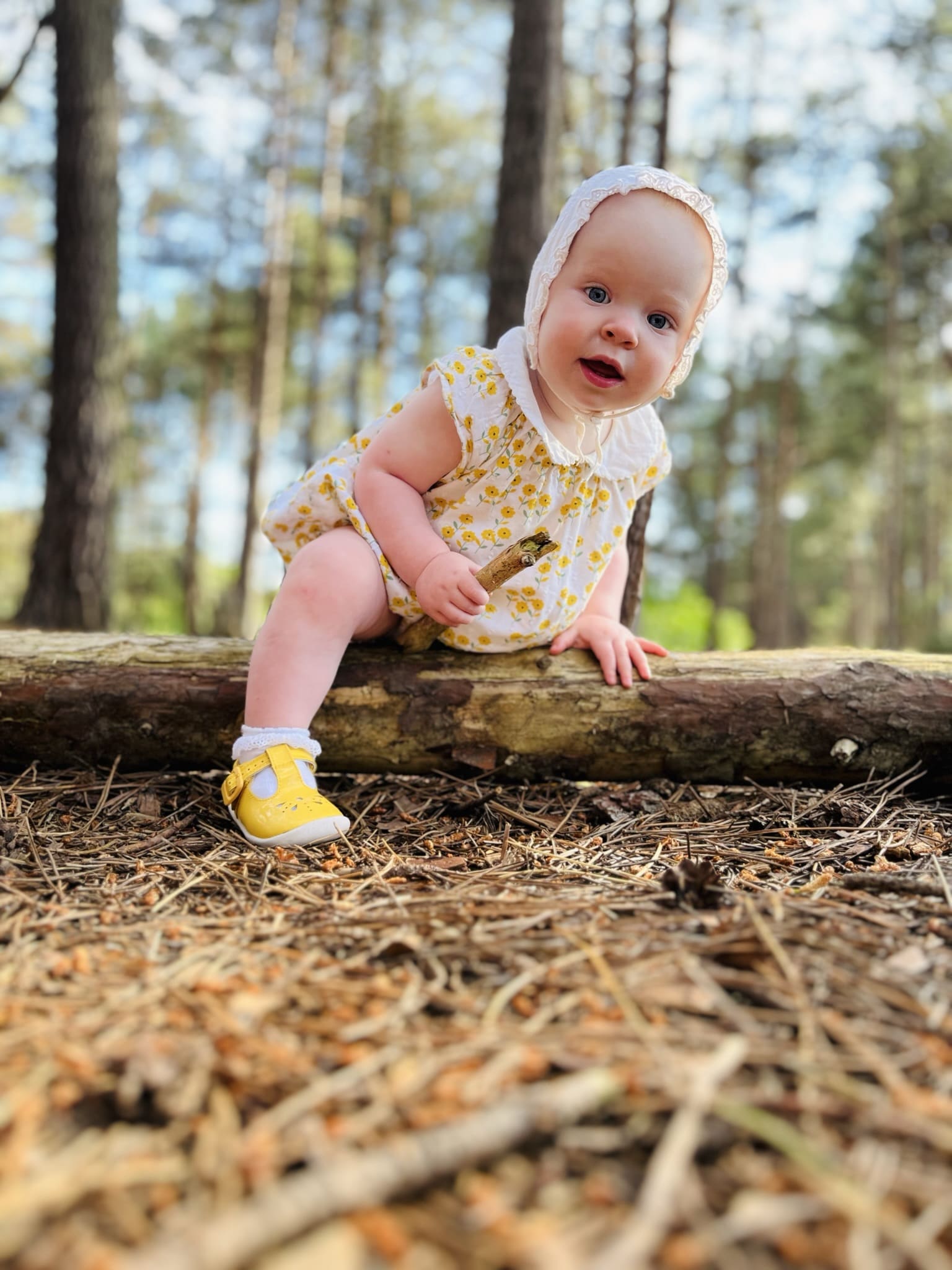 Baby Aila playing with sticks in the woods