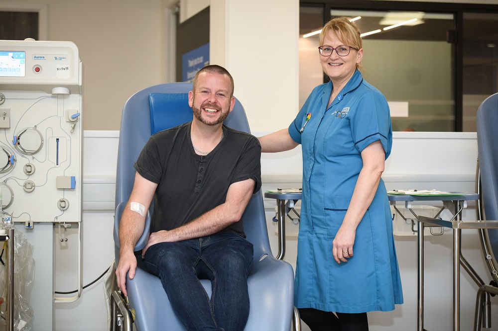 Plasma donor with a member of donation staff