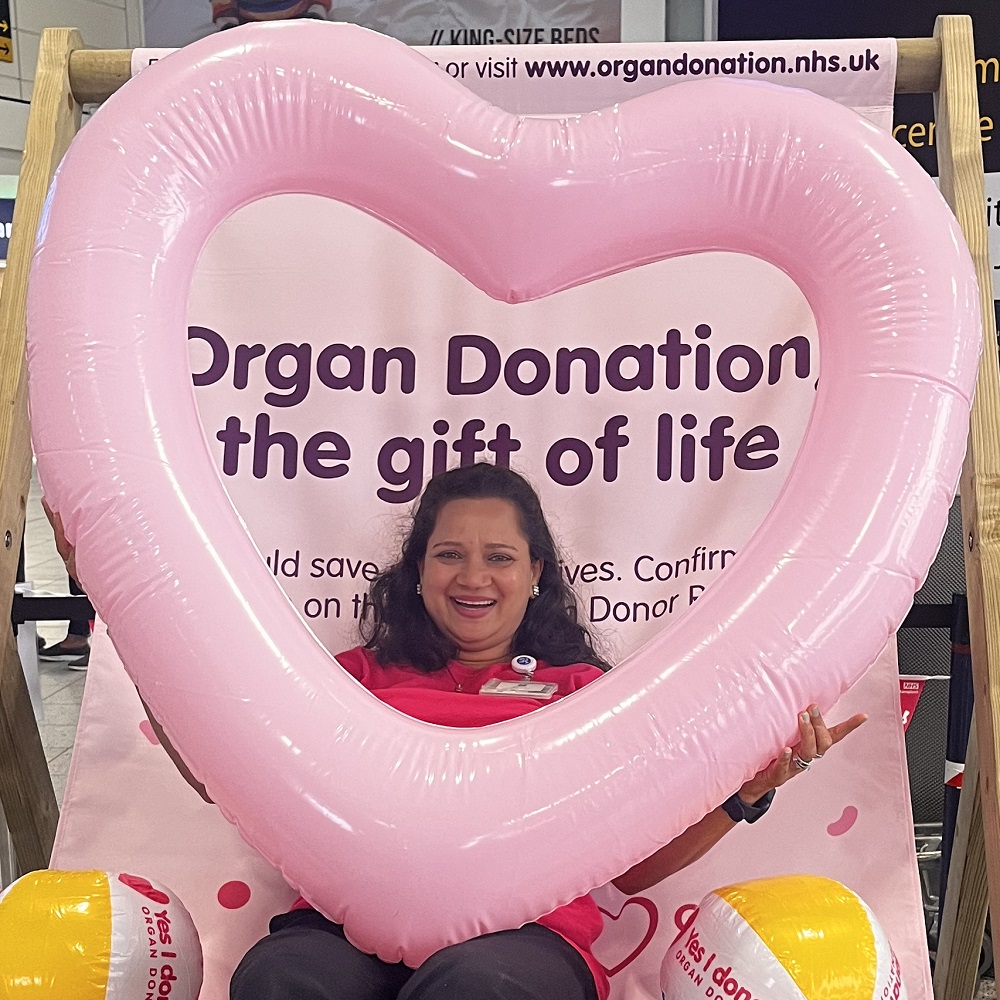 A member of the Organ Donation team poses with an inflatable heart at Gatwick Airport