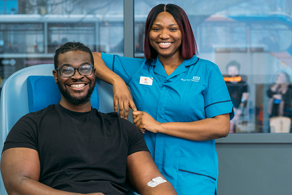 Donor and donor carer smiling after a blood donation