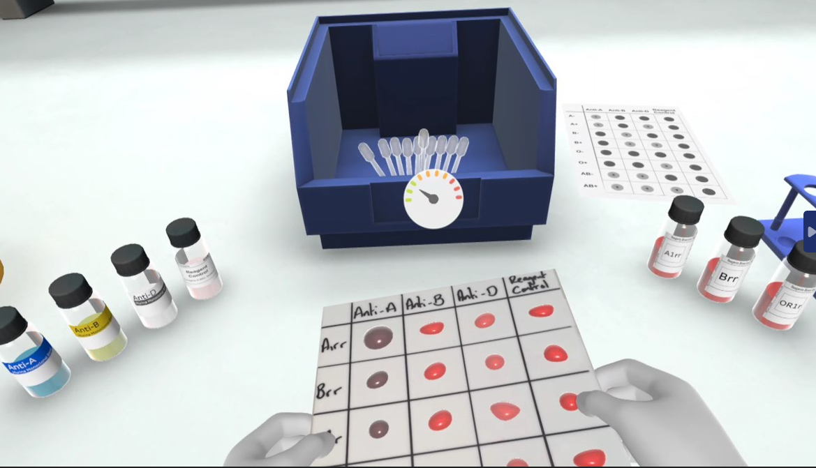 Inside VR experience, the user holds a blood matching sample card surrounded by test tubes and lab equipment