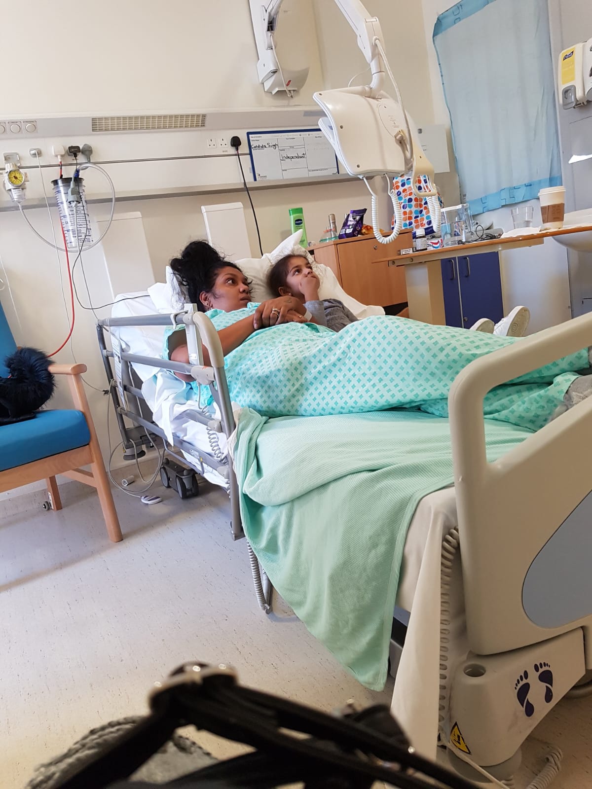 Candi in a hospital bed with her daughter