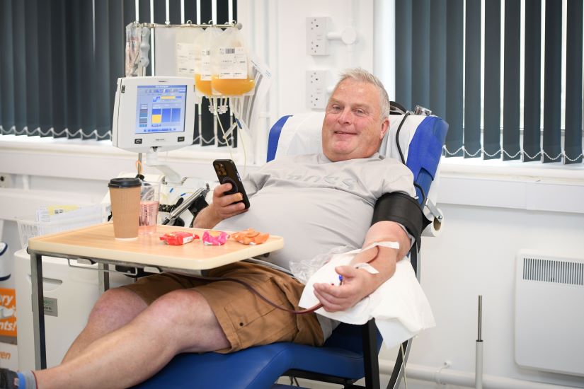 Platelets donor sitting in a chair during their donation