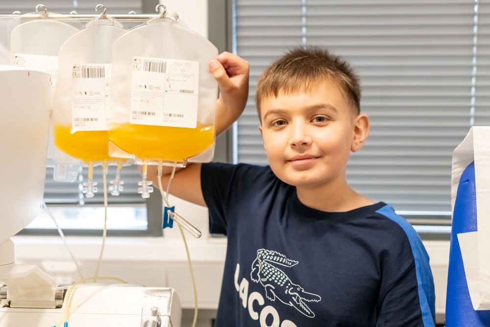 Child holding a bag of donated platelets