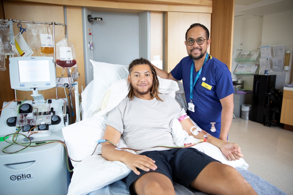 A young man making a stem cell donation with a nurse