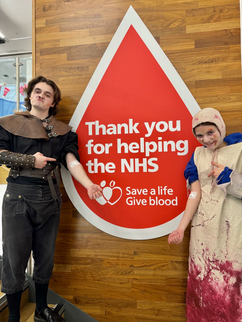 Characters from the London Dungeon pose with a blood donation sign