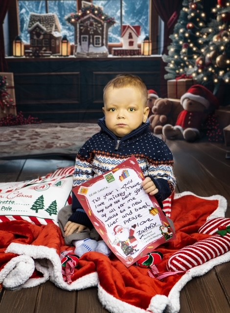 Zachary sat with his letter to Santa