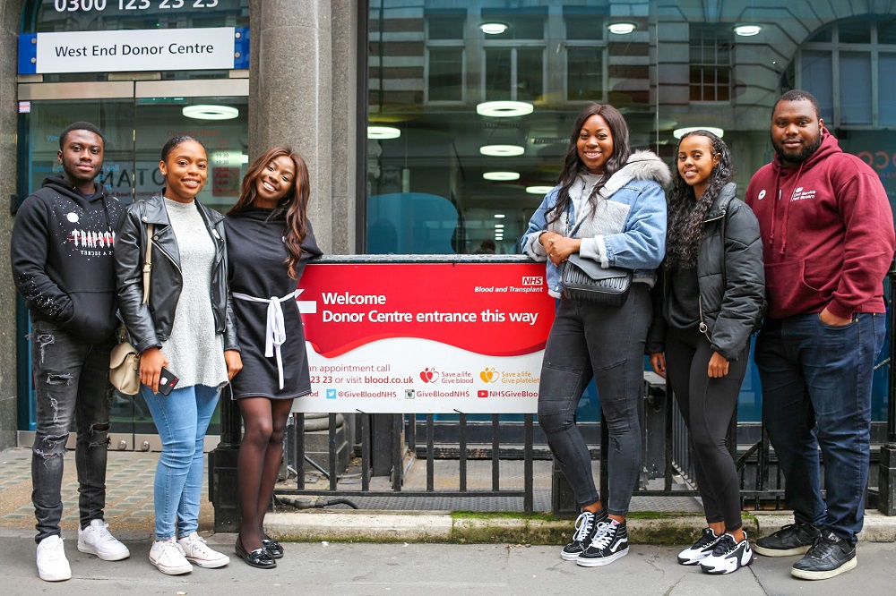 Group of young donors of Black heritage stand outside London West End Blood Donor Centre