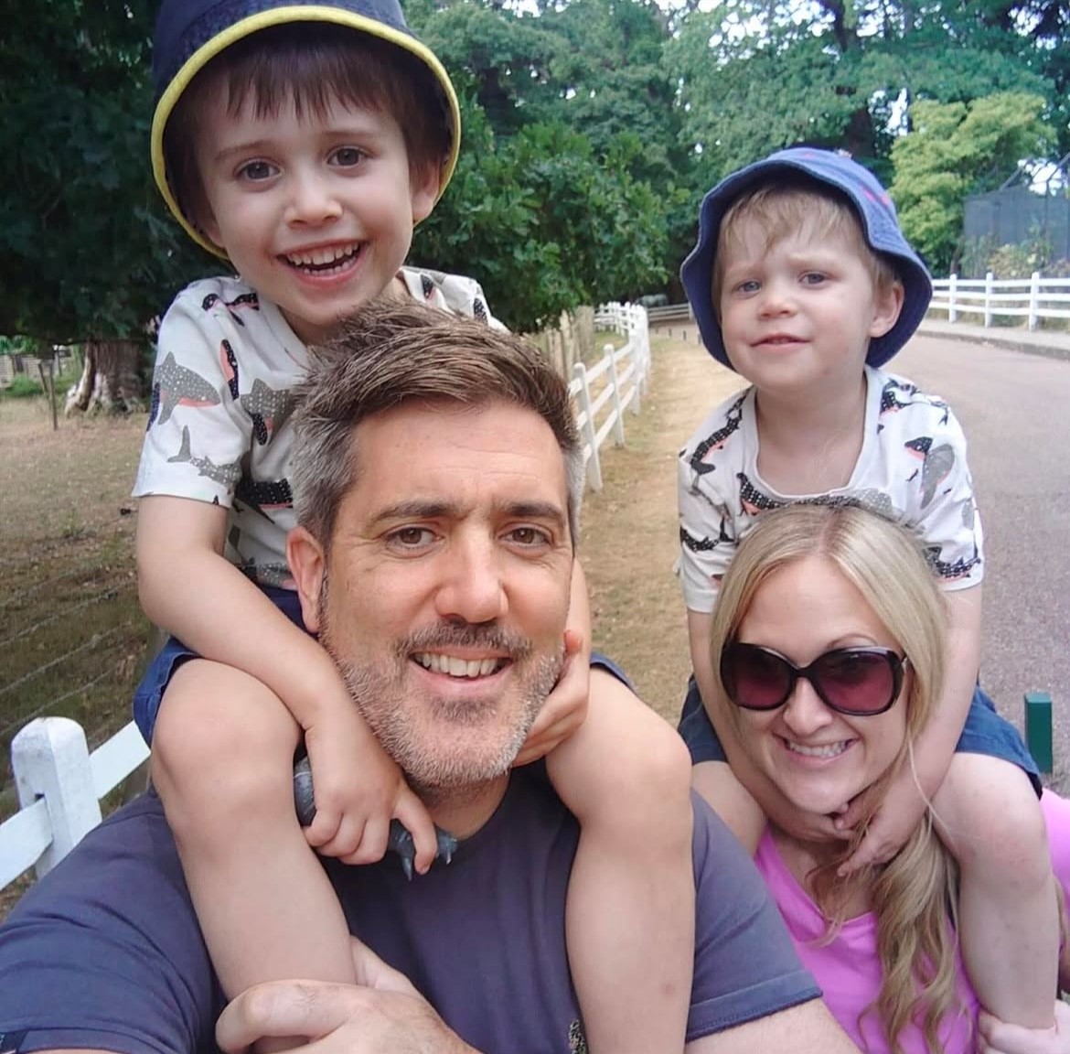 Mike and Lorna, with their 2 sons sitting on their shoulders