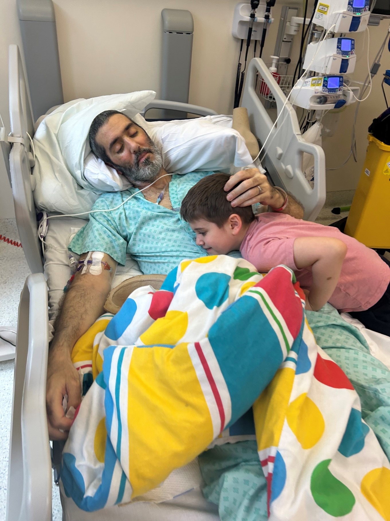 Mike, lying in a hospital bed