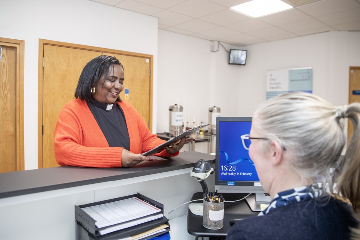 Donor arrives at reception and is handed clipboard with Donation Safety Check questionnaire