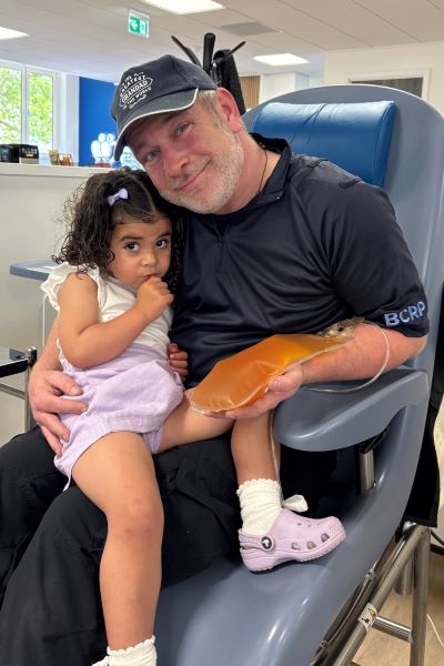 Paul in a donor chair with Suraiya