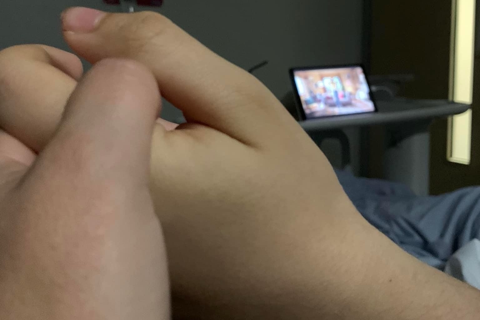 Sarah holding George's hand in ICU