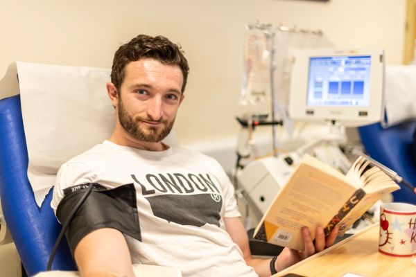 A platelet donor reading a book
