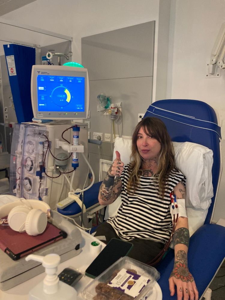 Johanna in hospital, giving a 'thumbs up' sign