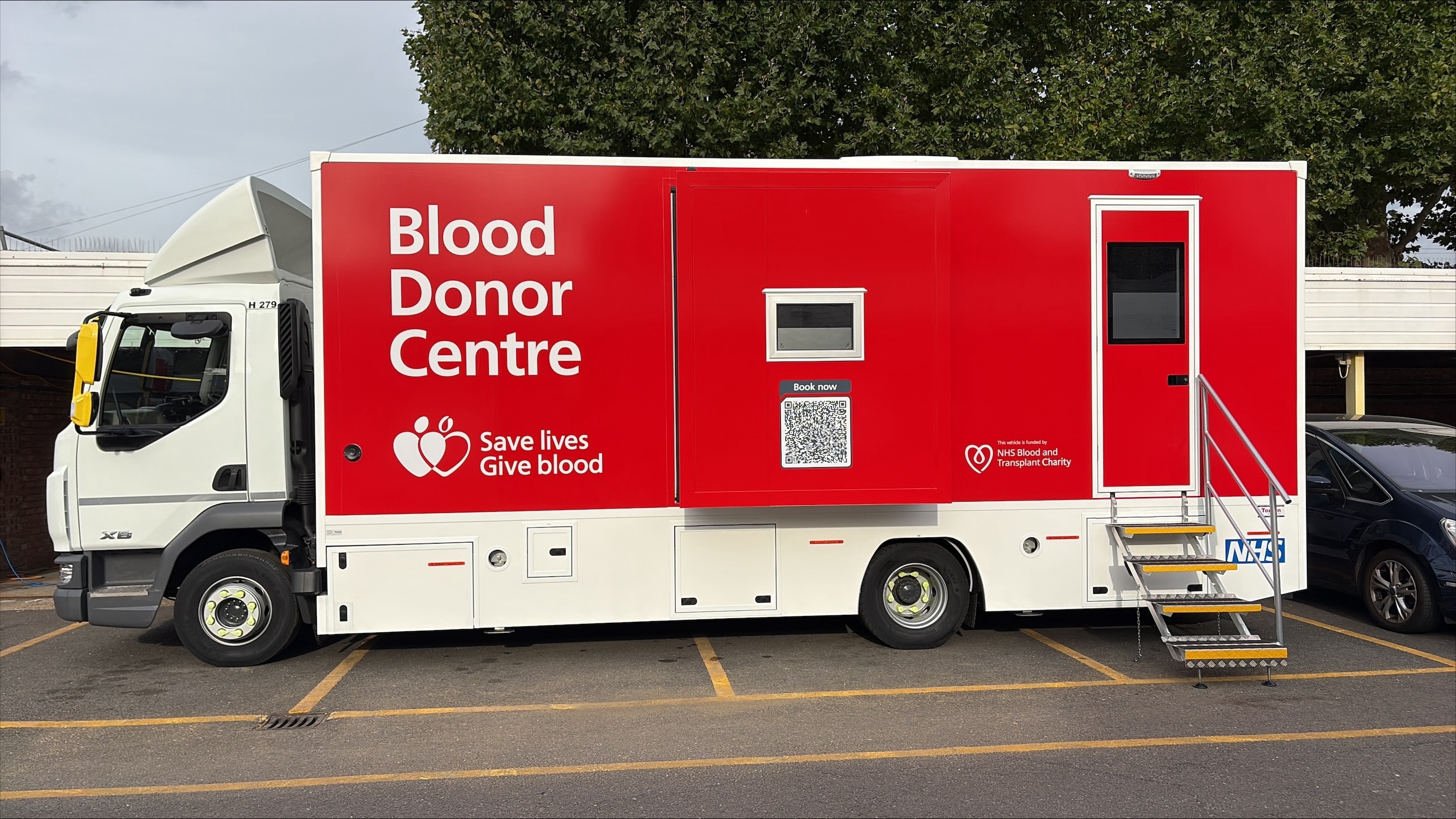 Exterior of mobile blood donor centre, which is parked in a car park