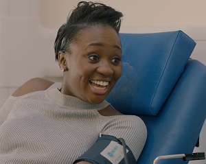 Remel London smiles while giving blood